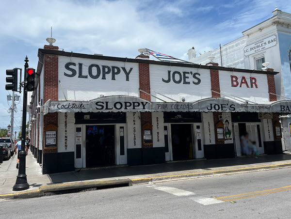 Exterior of Sloppy Joe’s Bar Key West on Duval Street with crowds enjoying live music