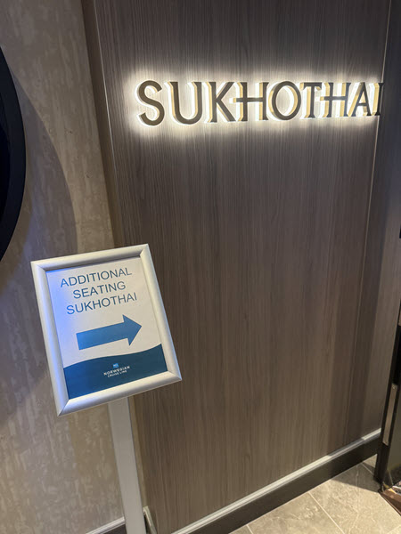 Sign that reads "additional seating Sukhothai"